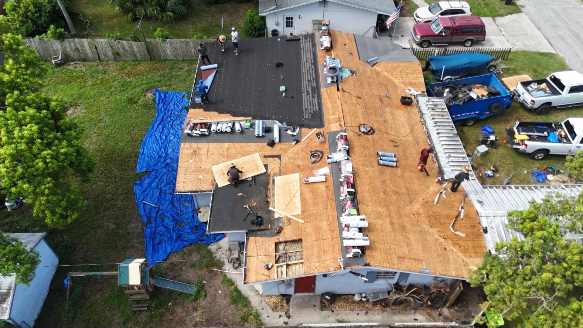 Drone view of the tear-off in Zephyrhills FL with half the roof stripped to plywood