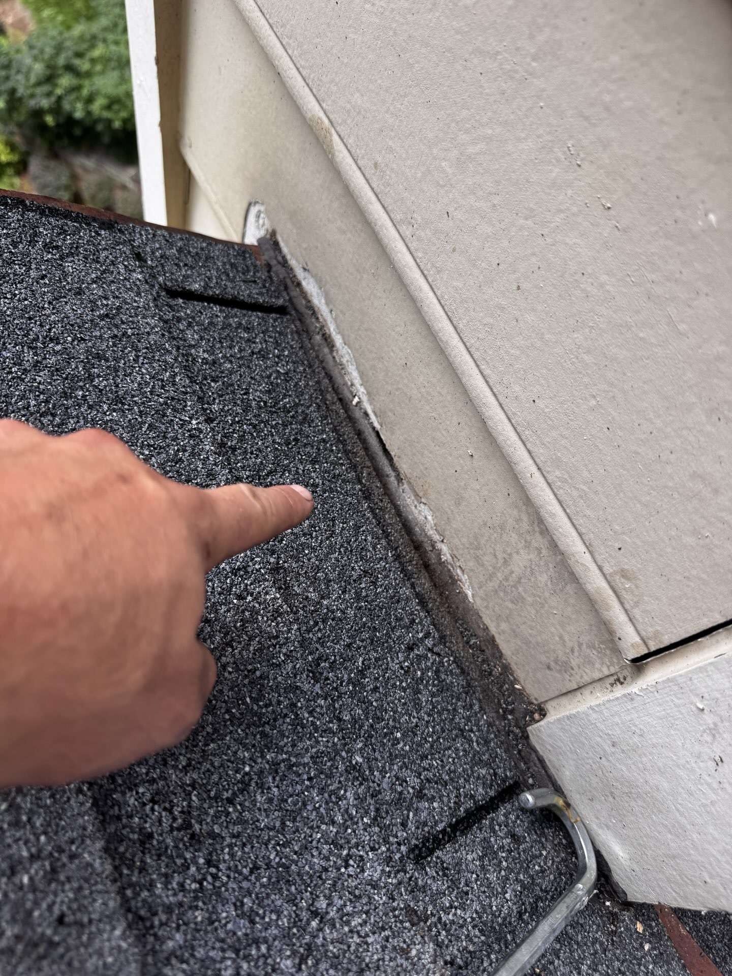Gap between shingles and siding at a sidewall on a Roswell GA roof