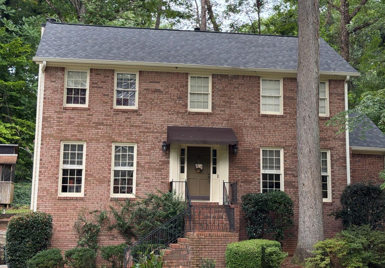 Front of the brick colonial in Roswell GA with its new shingle roof
