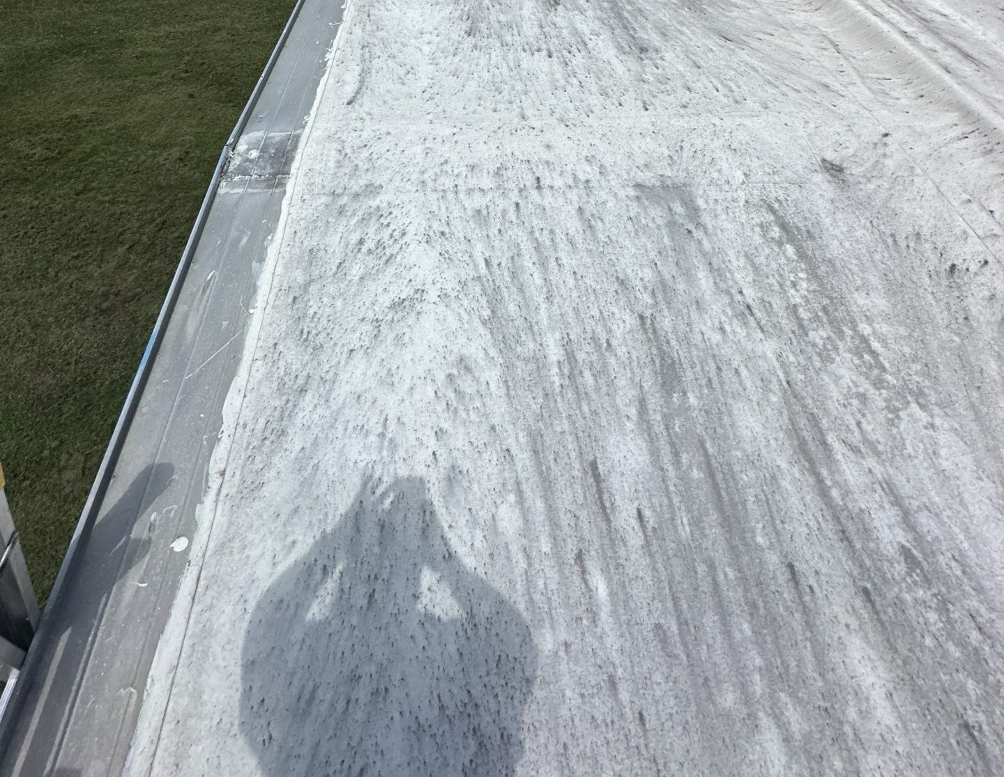 Chalky, streaked top layer on the old low-slope roof in Dade City FL