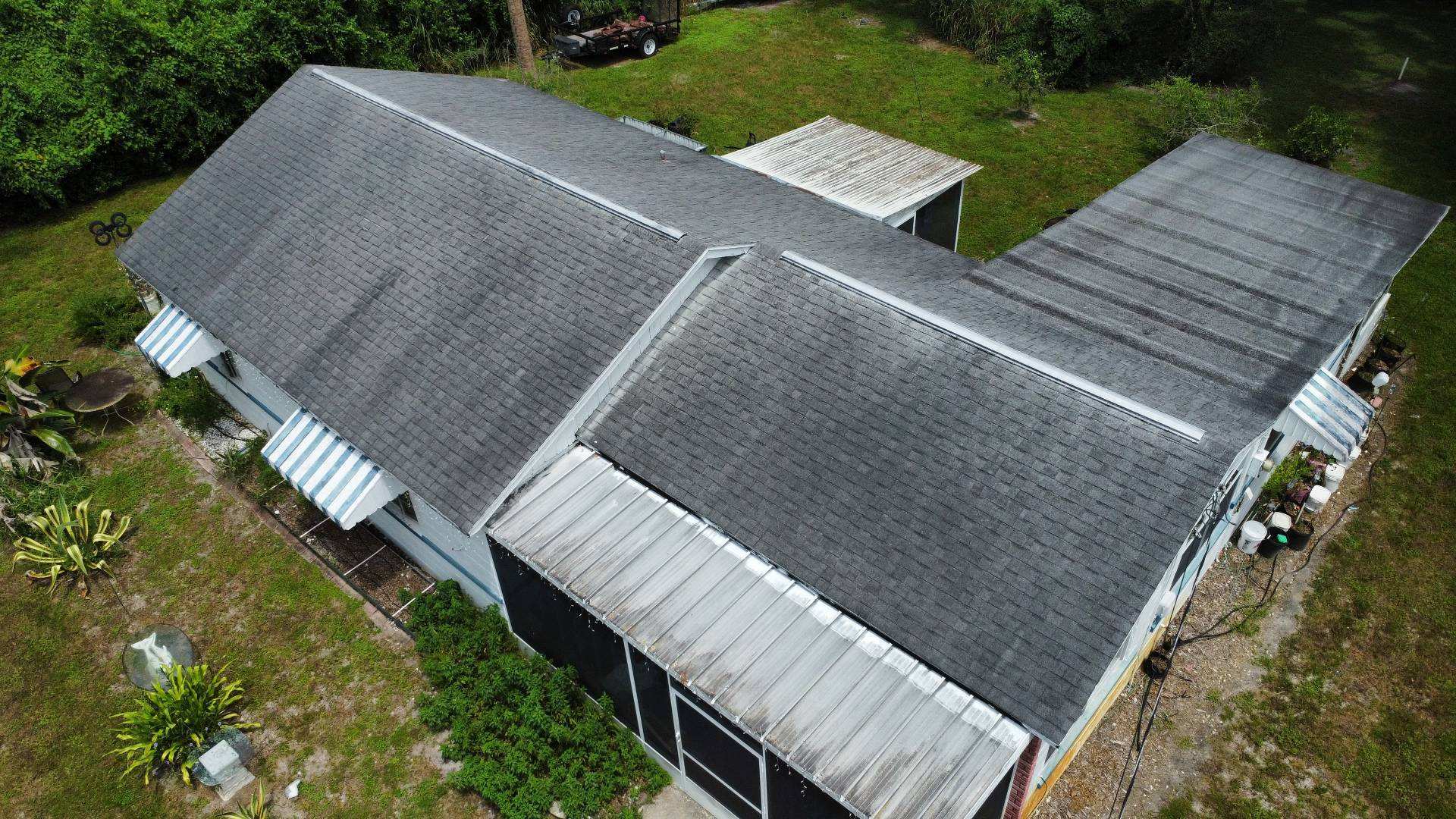Aerial view of the old three-tab shingle roof on a block home in DeBary FL