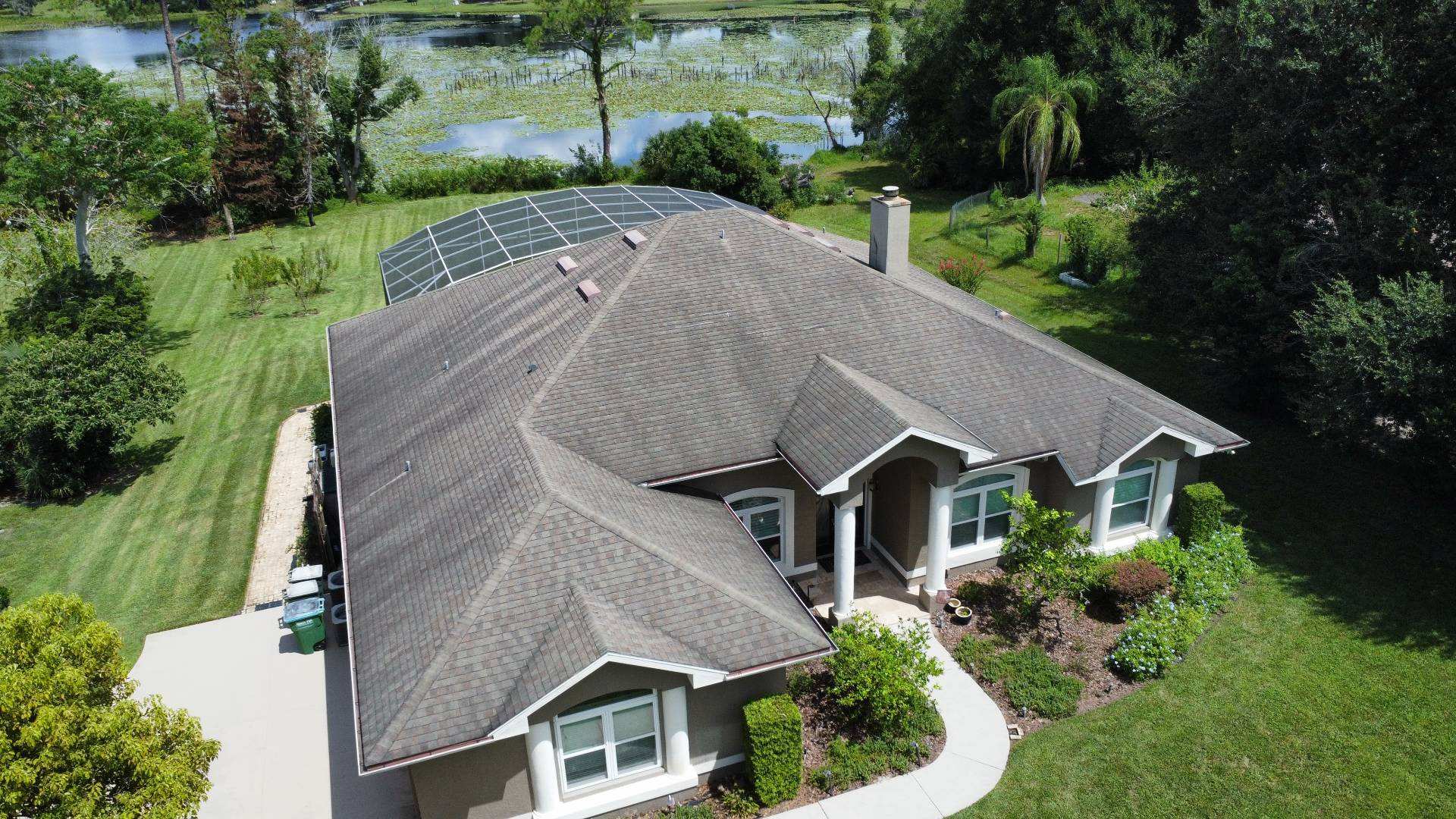 Aerial view of the old shingle roof on a lakefront home in Deltona FL