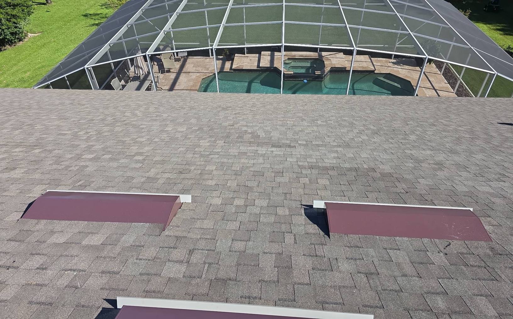 New shingle roof and vents above the screened pool in Deltona FL